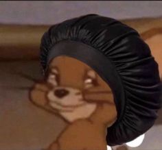 an animated squirrel wearing a black turban and looking at the camera while standing in front of a cartoon character