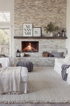 a living room filled with furniture and a fire place in the middle of it's wall