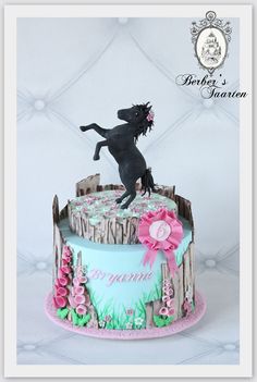 a birthday cake with a horse on top