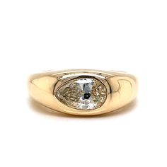 a yellow gold ring with an oval cut diamond in the center, on a white background