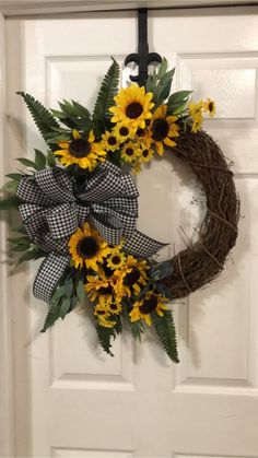 a sunflower wreath is hanging on the front door