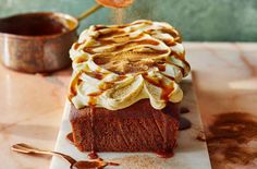 a piece of cake is being drizzled with caramel on the top