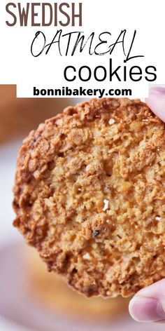 a close up of a person holding an oatmeal cookie