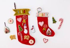 two christmas stockings with decorations on them sitting next to candy canes and candies