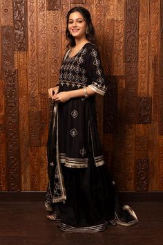 Black silk chanderi kurta with embroidered floral jaal patterns. Comes with organza sharara and embroidered dupatta.
Components: 3
Pattern: Embroidered
Type Of Work: Floral Jaal
Neckline: Round
Sleeve Type: Three Quarter
Fabric: Kurta - Silk chanderi, Sharara and Dupatta - Organza
Color: Black
Other Details: 
Back tassel tie kurta
Attached lining
Model Height: 5ft 7inches, wearing size M
Weight: 1500 gms
Occasion: Sangeet - Aza Fashions Raw Silk Traditional Wear With Mirror Work For Ceremonies, Anarkali Sharara With Mirror Work For Traditional Ceremonies, Anarkali Chanderi Palazzo Set For Traditional Ceremonies, Chanderi Palazzo Set With Dupatta For Traditional Ceremonies, Bollywood Chanderi Palazzo Set For Traditional Ceremonies, Bollywood Style Transitional Sharara For Traditional Ceremonies, Eid Sharara With Mirror Work For Traditional Ceremonies, Designer Chanderi Sharara With Mirror Work, Transitional Straight Kurta Sharara For Traditional Ceremonies