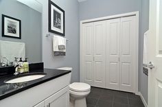 a white toilet sitting next to a bathroom sink