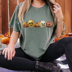 Creepy yet trendy! This popular garment dyed tee is super comfy! Size up for a trendy oversized look.  Spooky jack o lanterns line up on this tee to give you a bit of a vintage creepy vibe.   * Q U I C K * F A C T S * ✺ 100% ring-spun cotton ✺ Garment dyed,  Soft Washed ✺ Medium fabric (6.1 oz/yd² (206.8 g/m ✺ Relaxed fit- Size Up for oversized look ✺ Inside out and wash and dry normally (on cool for best results). Do not iron decoration. ✺ printed using DTG Direct to Garment printing.  ✺ Colors may vary due to computer monitors and printing inks. ✺ While we offer several shirt colors some may have a better contrast with the design. Keep that in mind when choosing your color.  * S I Z I N G * ✺ Sizing is relaxed fit so runs like men's, though not overly large. IF YOU WOULD LIKE AN OVERSIZE Vintage Pumpkin, Patch Shirt, Jack O'lantern, Patches Shirt, Pumpkin Face, Oversized Look, Iron Decoration, Halloween Vintage, Pumpkin Faces