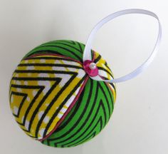 an ornament made out of fabric with a ribbon around it's neck