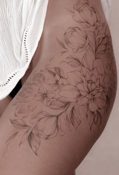 a woman's thigh with flowers on it