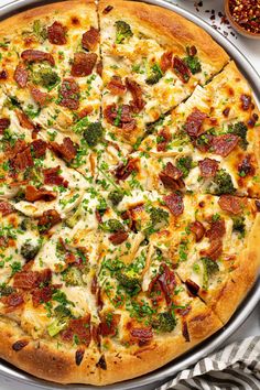 a pizza sitting on top of a pan covered in cheese and broccoli toppings