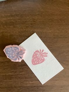 a piece of paper with a strawberry stamp on it