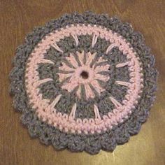 a crocheted doily on a wooden table