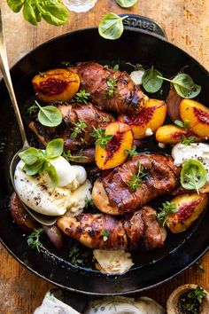 a pan filled with meat and potatoes on top of a wooden table