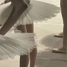 several dancers in white tutus and ballet shoes