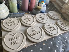 decorated cookies with words on them sitting on a table next to other crafting supplies