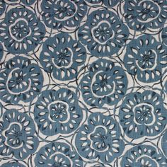 a blue and white fabric with circular designs on the front, in various sizes and colors