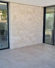 an empty patio with sliding glass doors leading outside