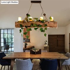 a dining room table and chairs with candles hanging from the ceiling