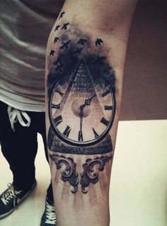 a man with a clock tattoo on his leg