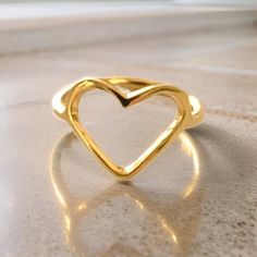 The dainty heart ring is handmade in USA. The ring is lightweight and is a perfect accent to any outfit. Its made of pewter and dipped in a 24k or silver finish giving it that beautiful sheen.  -Makes a perfect gift -Made in USA -Made to order -Base metal pewter -Finish 24k gold Summer Heart-shaped Gold Jewelry, Gold Midi Rings As A Gift For Summer, Gold Midi Rings As Summer Gift, Bohemian Heart-shaped Anniversary Rings, Gold Ring For Summer Promise, Bohemian Heart-shaped Rings For Gifts, Gold Promise Ring For Summer, Summer Gold Promise Ring, Handmade Bohemian Heart Ring Gift