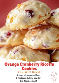 orange cranberry ricotta cookies are stacked on top of each other in front of a red background