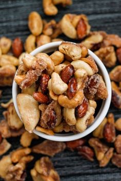 nuts are in a white bowl on a table