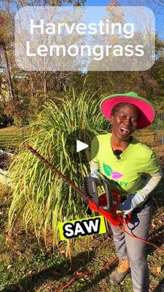 a woman in a pink hat is holding a chainsaw and smiling at the camera