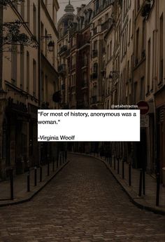 an empty street with buildings in the background and a quote from virginia wool on it