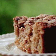 a piece of cake sitting on top of a white plate next to a green background