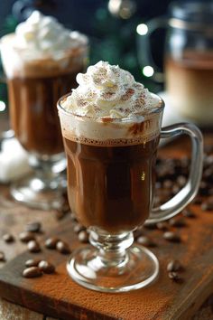 two glasses filled with hot chocolate and whipped cream