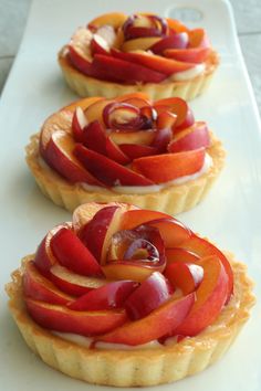 three tarts with apples and cream filling on a white platter