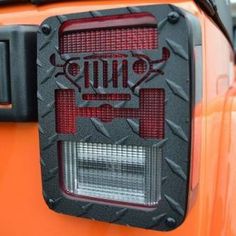 an orange jeep with the emblem on it's grill and tail light is shown