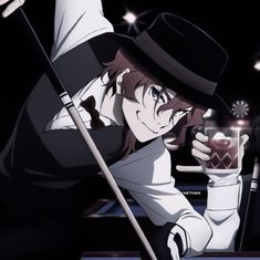 a man with a top hat holding a glass in his hand while sitting at a pool table