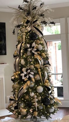 a christmas tree decorated with black and gold ornaments