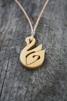 "This very unique Celtic Necklace will be made for you, or a loved one, in my studio on the West of Ireland. This beautiful Celtic Swan pendant features a piece of boxwood, recycled from musical instruments constructed by a local luthier. As a musician myself, I take enormous satisfaction in creating a necklace whose inherent wood has previously featured in a beautiful hand-made flute. Also, part of boxwood's attractiveness is its durability and ability to stand the test of time and of course th Artisan Wooden Jewelry As A Gift, Handmade Wooden Necklace Gift, Artisan Wood Jewelry Gift, Artisan Natural Wood Necklace As A Gift, Artisan Necklace In Natural Wood As A Gift, Natural Carved Necklaces As Gift, Artisan Necklaces In Natural Wood As Gift, Artisan Natural Wood Necklaces For Gift, Symbolic Carved Necklace For Gifts