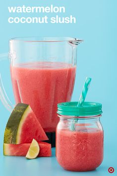 a watermelon smoothie in a mason jar next to a slice of watermelon