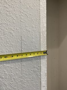 a measuring tape is hanging on the wall