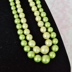 This vintage necklace is lovey! Double-stranded, it features plastic beads in two shades of green and it has a thin metal clasp.  Measures 20.75" from end to end. Maker : Hong Kong (marked on the clasp).  Time Period : 1960's/1970's. Condition : Good.. There is tarnishing and scratching throughout the clasp, light scratching on the bead on the clasp, and light scuffing/wear on the plastic beads.  SHIPPING POLICY :  Orders are shipped within 1-3 business days, Ground Shipping with USPS. We cannot guarantee the estimated delivery dates since they might take longer to deliver than expected by the post office. We are not responsible for lost or stolen packages or incorrectly provided shipping addresses, but we're happy to help as much as we can if an issue arises.  RETURN / EXCHANGE POLICY : Green Beads, Time Period, Plastic Beads, Green Bead, Post Office, Vintage Necklace, Shades Of Green, Favorite Jewelry, Hong Kong