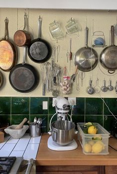 pots and pans are hanging on the wall