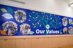 a blue wall with many pictures on it and the words our values painted on it