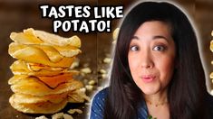 a woman is looking at some potato chips on the table, and there are two stacks of potatoes in front of her