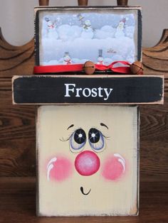 a close up of a wooden sign with a clown face on it's front