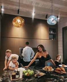 a group of people standing around a kitchen counter