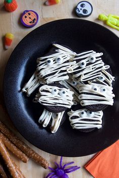 halloween treats are arranged on a black plate