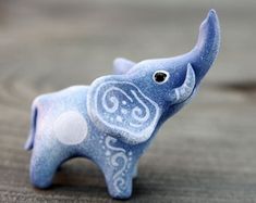 an elephant figurine sitting on top of a wooden table