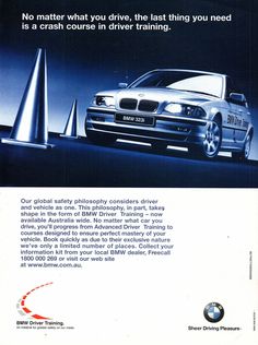 an advertisement for the bmw car that is parked in front of some cones and poles