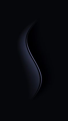 an abstract black background with wavy lines and curves in the center, on a dark surface