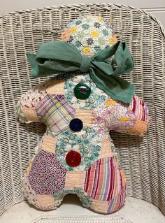 a stuffed animal sitting on top of a chair next to a wicker wallpaper