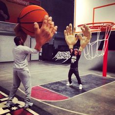 two men are playing basketball on an indoor court with the words wherever this is, i will find it and play it