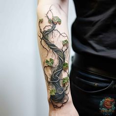 a woman's arm with a tree and leaves on it